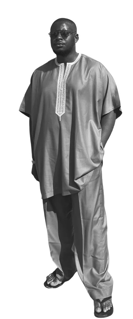Samuel standing in a grey kaftan